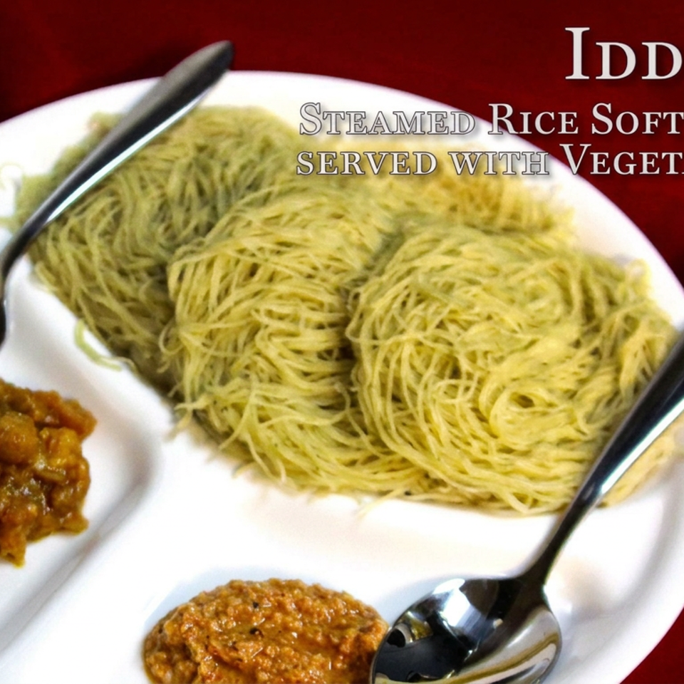 Plate of steamed rice vermicelli iddiappam served with vegetable korma on a red tablecloth.